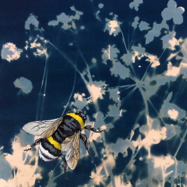 bee on blue floral background